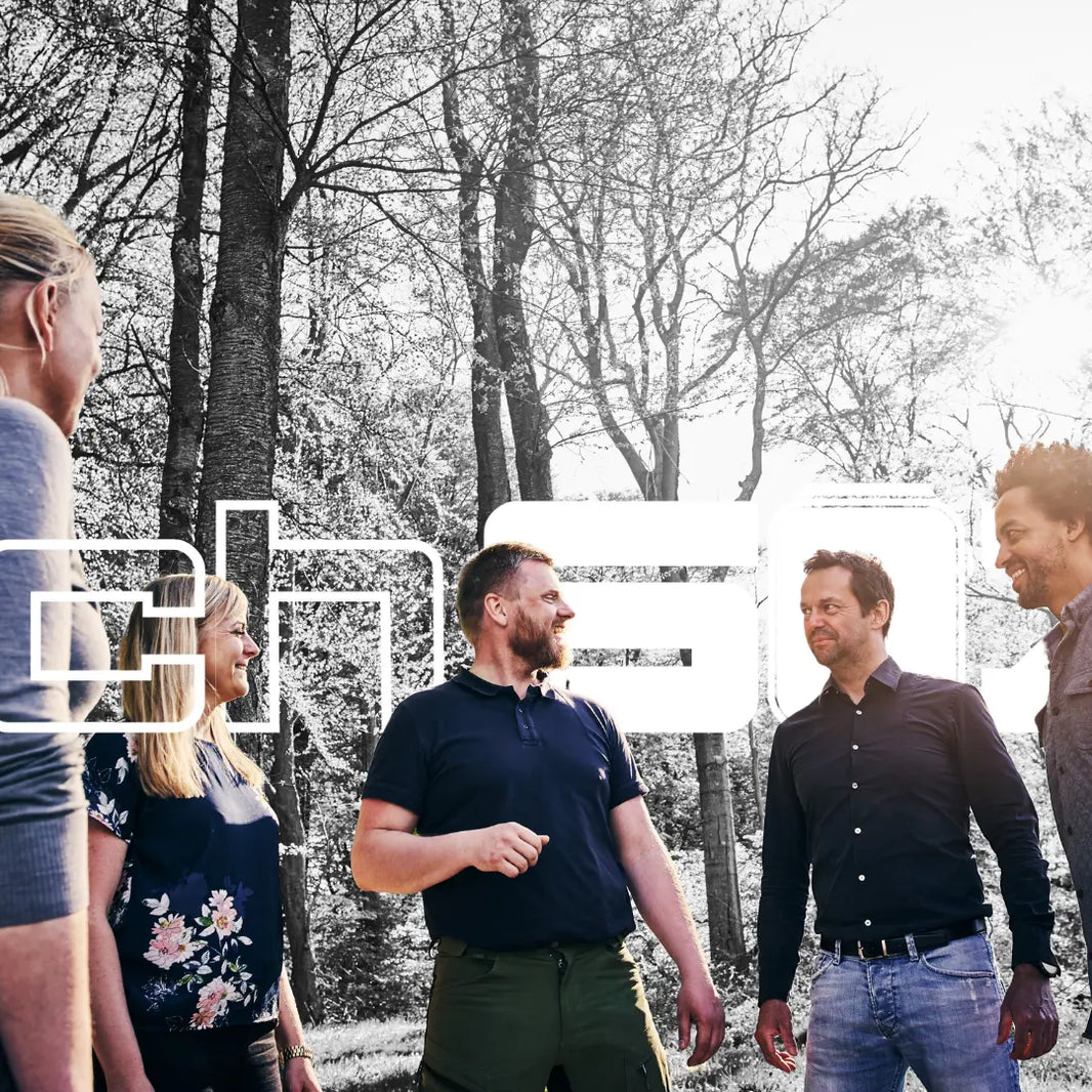 A warm and inviting scene that emphasizes community and sustainability. The image features a diverse group of people in an outdoor setting, such as a park or a community event, showcasing their wristwatches with protective sleeves. 